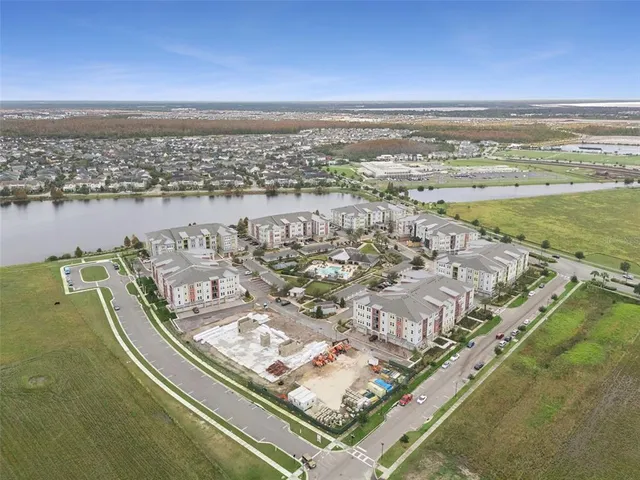 an aerial view of multiple houses with yard
