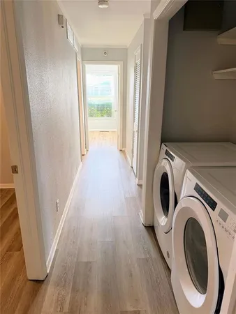 a view of a hallway with washer and dryer