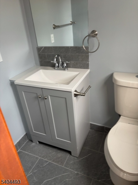 892 Hobson Street Union, NJ 07083 - Photo 11 of 14 a bathroom with a sink toilet and vanity