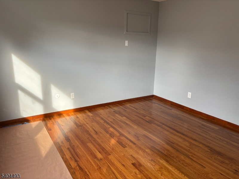 892 Hobson Street Union, NJ 07083 - Photo 12 of 14 a view of an empty room with wooden floor