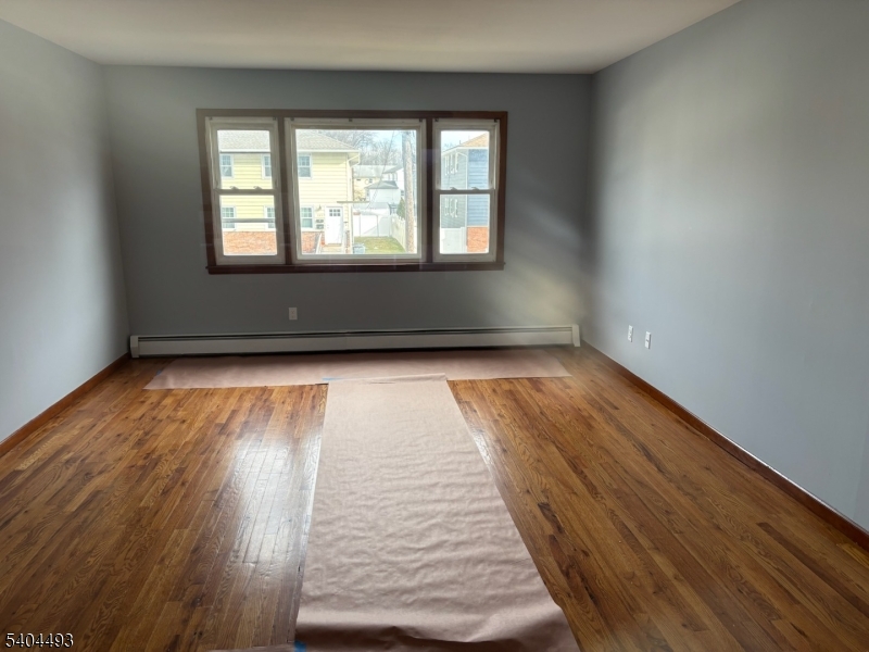 892 Hobson Street Union, NJ 07083 - Photo 2 of 14 wooden floor in an empty room with a window