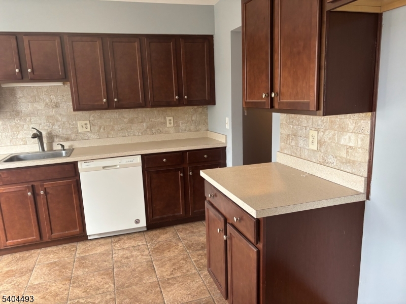 892 Hobson Street Union, NJ 07083 - Photo 5 of 14 a kitchen with a sink a stove and cabinets