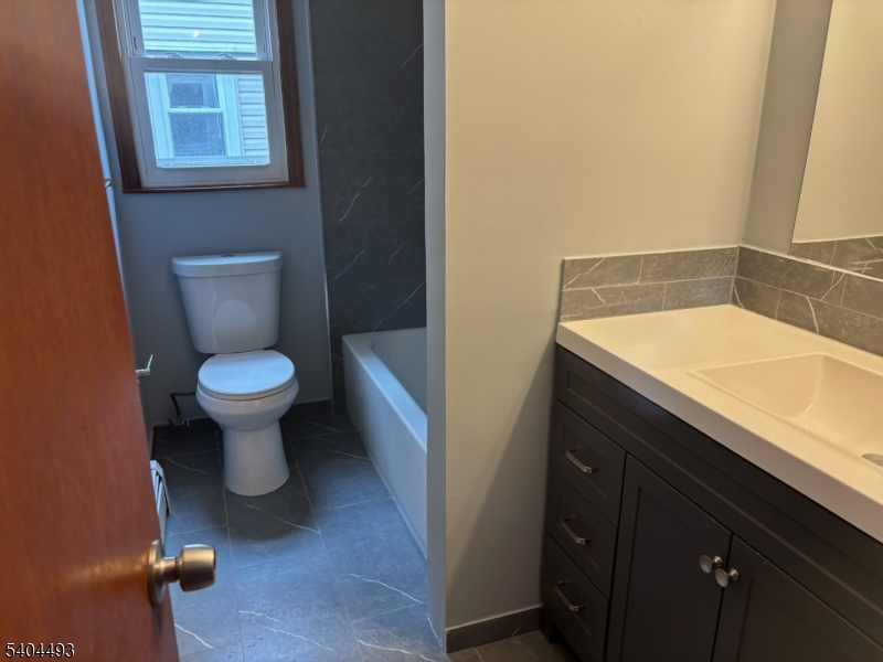 892 Hobson Street Union, NJ 07083 - Photo 9 of 14 a bathroom with a sink and a toilet