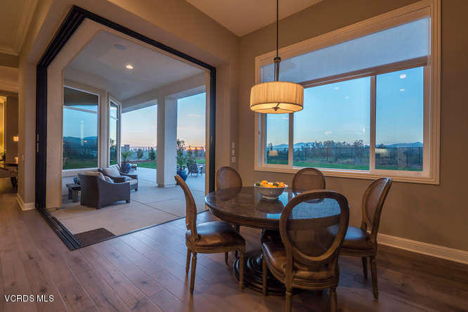 7367 Nicklaus Road Moorpark, CA 93021 - Photo 14 of 41 a dining room with furniture a chandelier and wooden floor