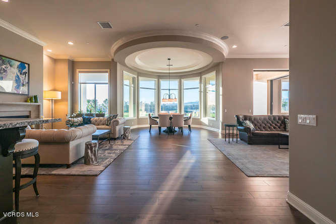 7367 Nicklaus Road Moorpark, CA 93021 - Photo 3 of 41 a living room with furniture a wooden floor and a large window