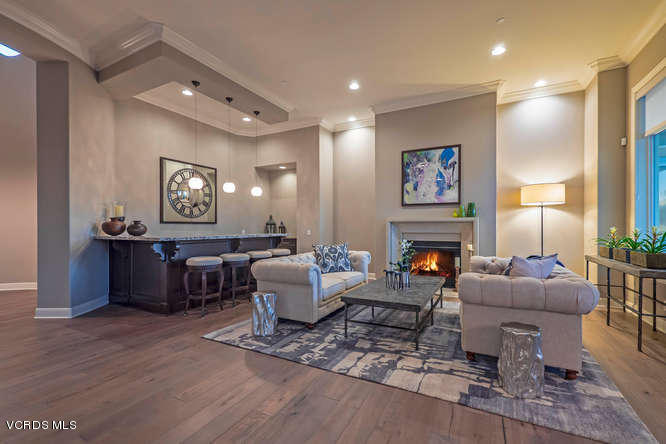 7367 Nicklaus Road Moorpark, CA 93021 - Photo 4 of 41 a living room with fireplace furniture and a wooden floor