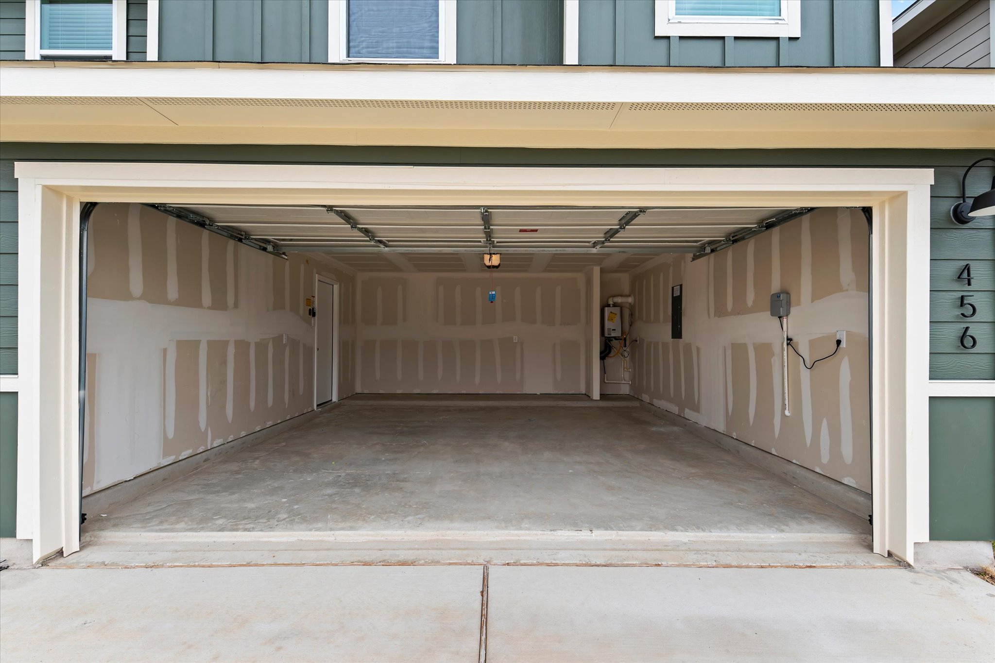 456 Sandringham Loop Kyle, TX 78640 - Photo 5 of 40 A spacious, two-car garage awaits your vehicles, offering ample storage and direct access to the home.