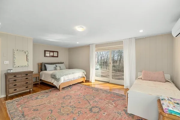 a bedroom with a large bed and a window