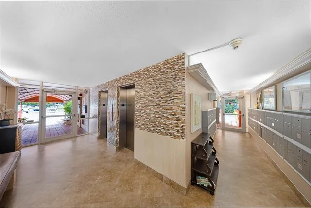 a hallway with hardwood stairs and furniture