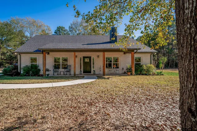 a living room with furniture fireplace and flat screen tv
