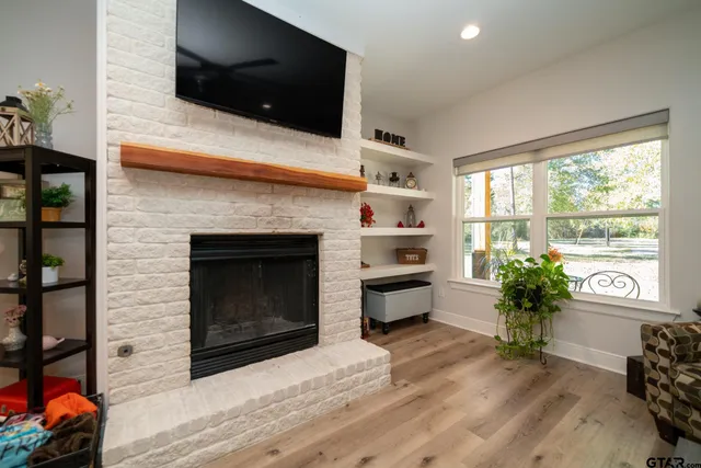 a bed room with a bed a television and a large window