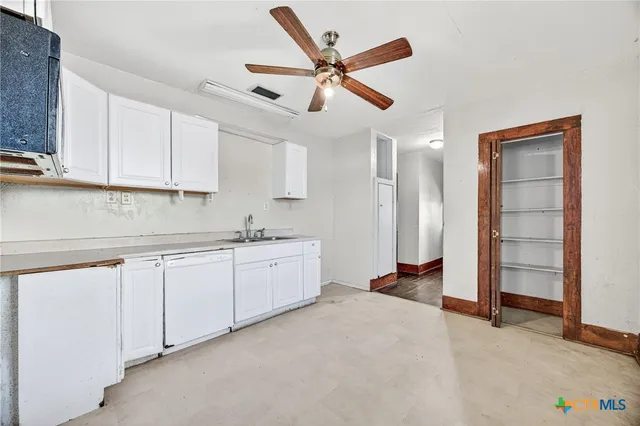a kitchen with white cabinets