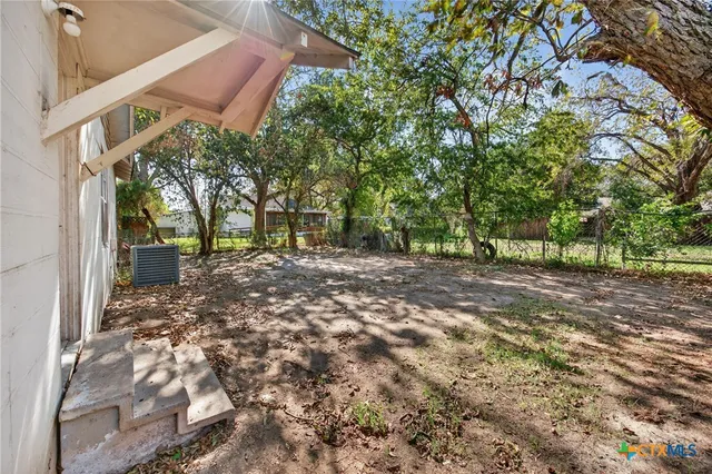 a view of a house with a tree
