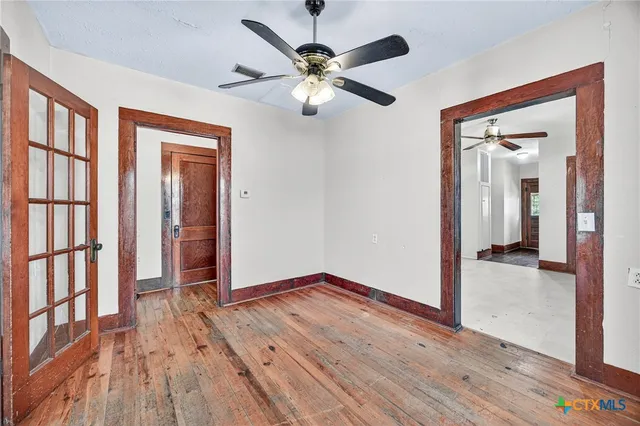 wooden floor in an empty room with a window