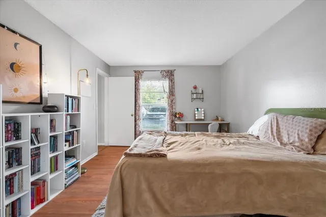 a bedroom with a bed and a book shelf