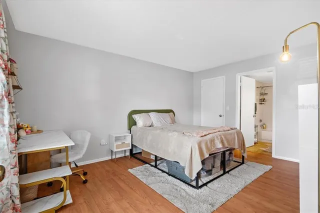 a bed sitting in a room next to a window