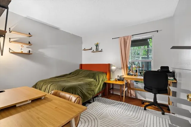 a bedroom with two beds and a chair