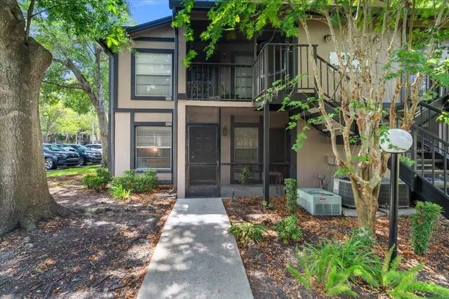 a backyard of a house with plants and outdoor seating