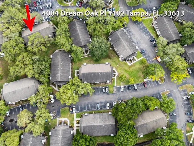 an aerial view of a house with a garden and lake view