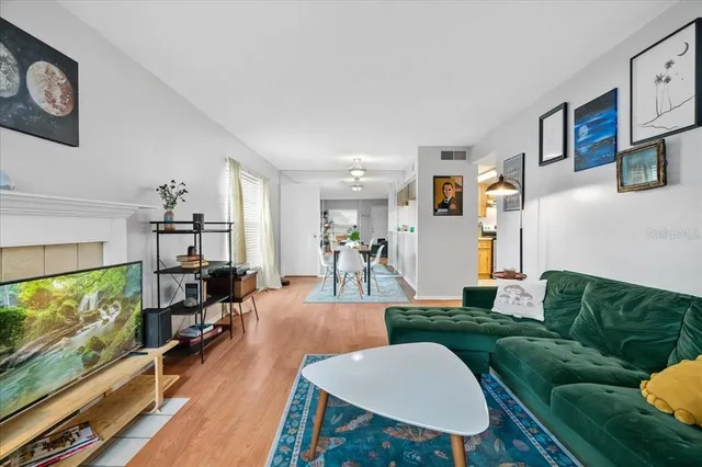a living room with furniture a rug and a flat screen tv