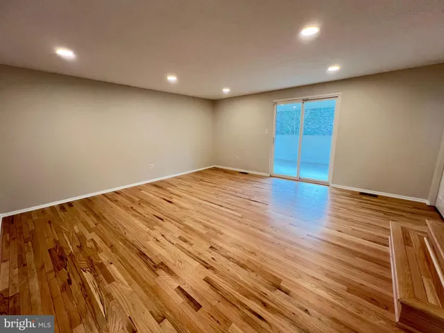 an empty room with wooden floor