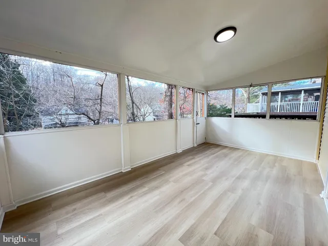 a view of a room with window and hardwood