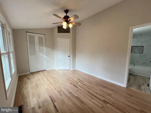 wooden floor in an empty room with a mirror