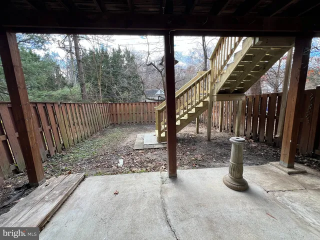 a view of a house with wooden deck front of house