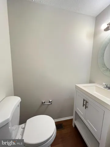a bathroom with a toilet sink and vanity