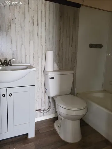 a white toilet sitting next to a bathroom sink