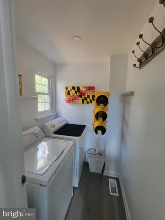 a bathroom with a sink toilet and window