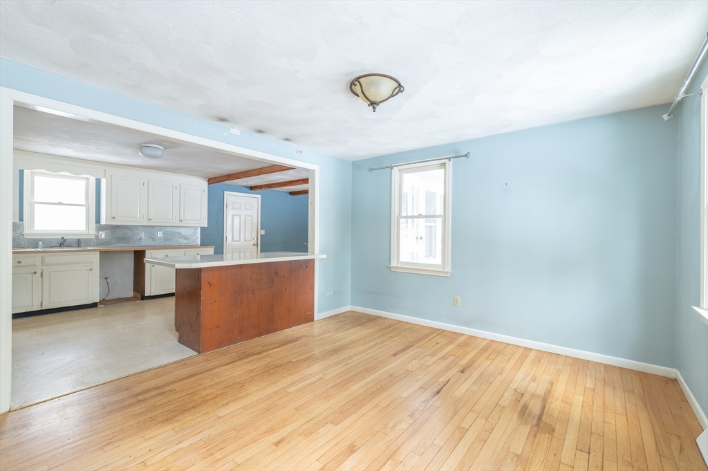 16 Michael Road Bourne, MA 02559 - Photo 14 of 41 a view of kitchen and empty room with wooden floor