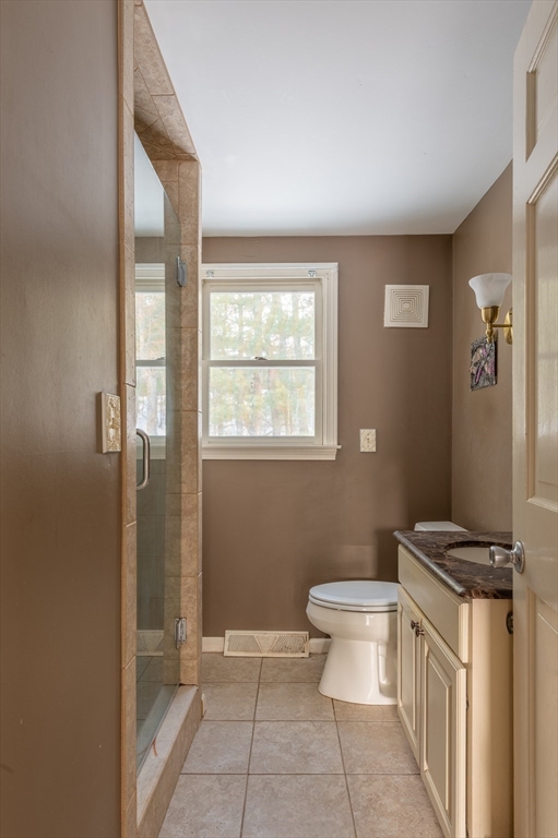 16 Michael Road Bourne, MA 02559 - Photo 20 of 41 a bathroom with a granite countertop toilet a sink a mirror a window and vanity