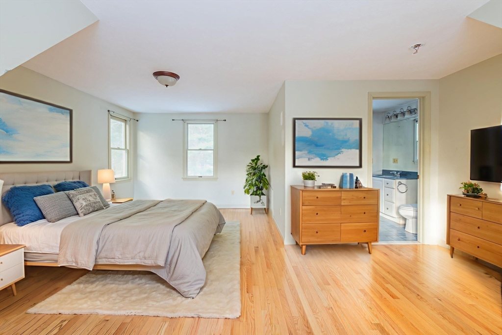 16 Michael Road Bourne, MA 02559 - Photo 22 of 41 a bedroom with a large bed and a flat tv screen