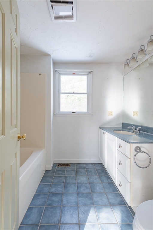 16 Michael Road Bourne, MA 02559 - Photo 25 of 41 a bathroom with a granite countertop sink a toilet and bathtub