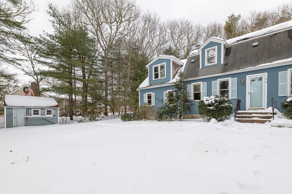 16 Michael Road Bourne, MA 02559 - Photo 4 of 41 a front view of a house with a yard covered in snow