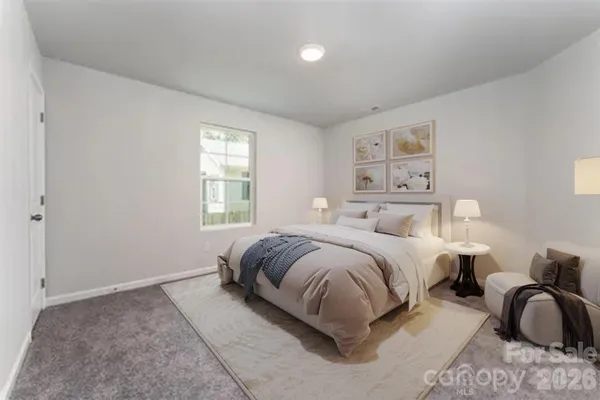 a spacious bedroom with two beds and a window