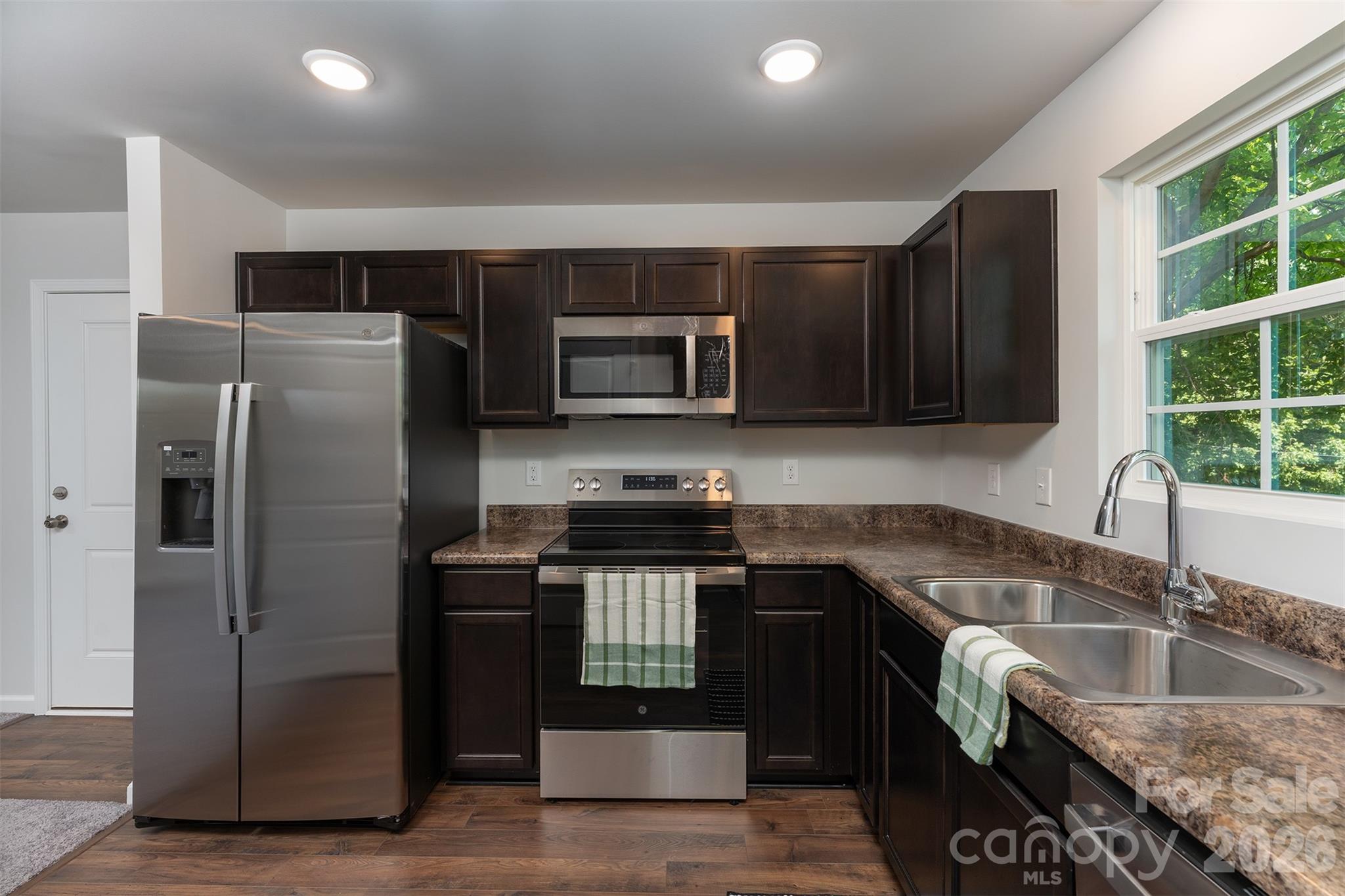 27 Forest Park Road Marion, NC 28752 - Photo 4 of 21 a kitchen with granite countertop a refrigerator and a sink