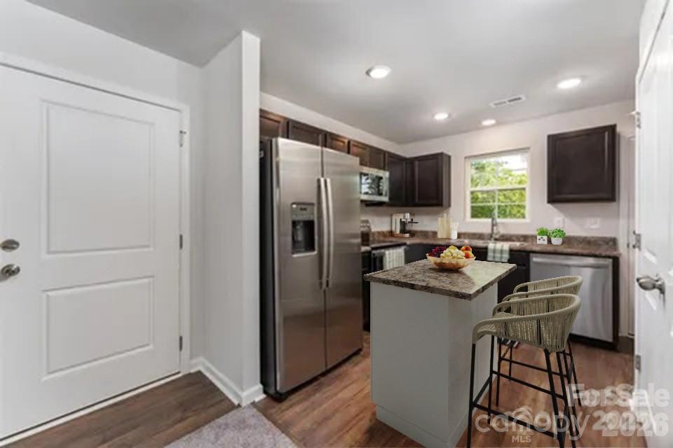 27 Forest Park Road Marion, NC 28752 - Photo 5 of 21 a kitchen with a refrigerator a sink a stove a microwave a dining table and chairs