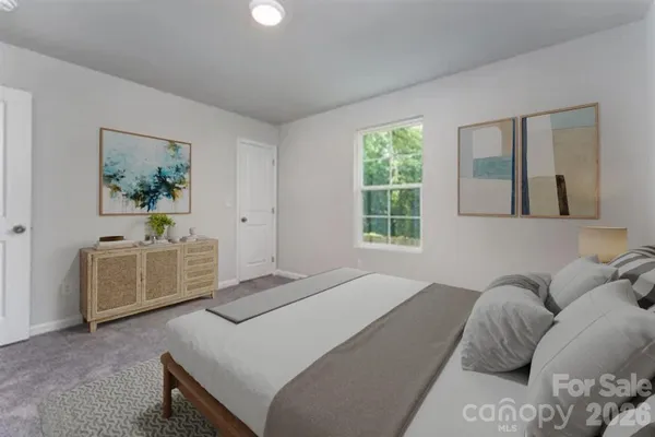 a bedroom with a bed and a couch