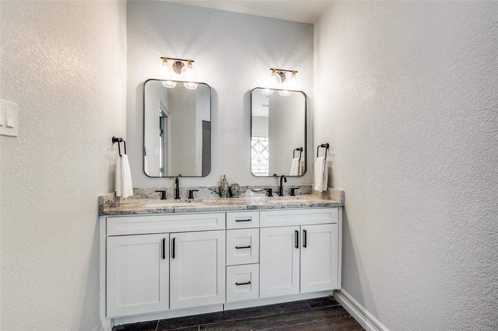 6417 Silver Wind Court Arlington, TX 76016 - Photo 11 of 18 a bathroom with double vanity sinks and a mirror