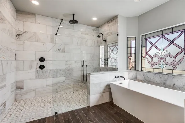a bathroom with a bathtub and a shower