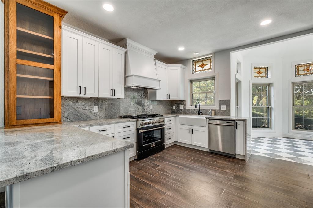 6417 Silver Wind Court Arlington, TX 76016 - Photo 8 of 18 a kitchen with granite countertop white cabinets and white appliances