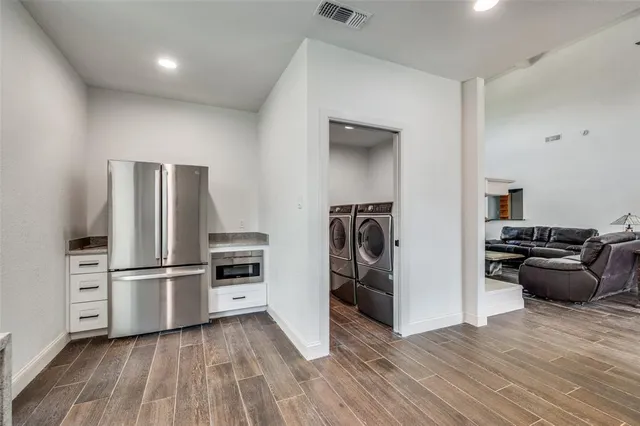 a kitchen with a refrigerator and a stove top oven