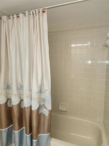 a white toilet sitting next to a shower