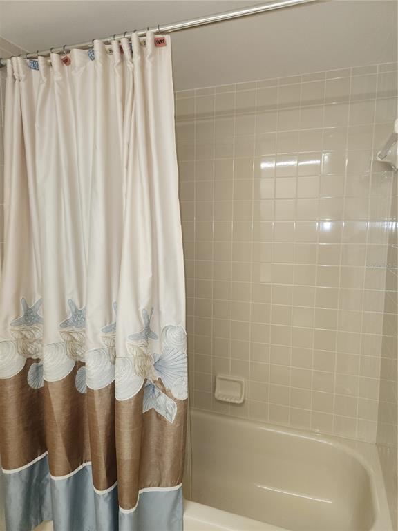 6503 Stone River Road, Unit 109 Bradenton, FL 34203 - Photo 17 of 39 a bathroom with a shower curtain