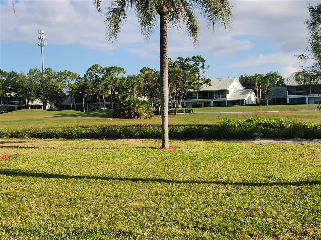 6503 Stone River Road, Unit 109 Bradenton, FL 34203 - Photo 22 of 39 a front view of a house with a yard