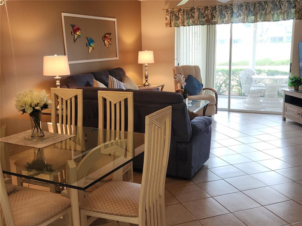 6503 Stone River Road, Unit 109 Bradenton, FL 34203 - Photo 4 of 39 a living room with furniture and wooden floor