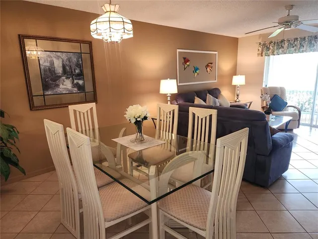 a living room with furniture a table and chair