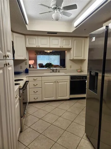 a bedroom with a large bed and a lamp